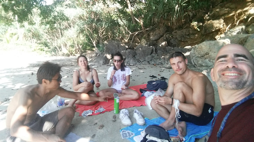 Picture of 3 guys and 2 girls on a beach picnic