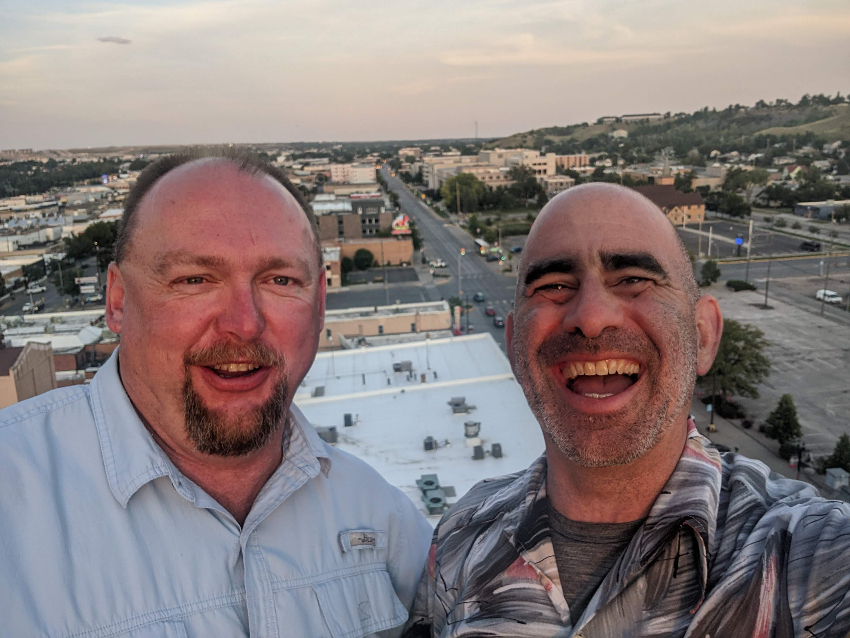 Tom Deus and Clay on top of the Alex Johnson Hotel with Rapid City below