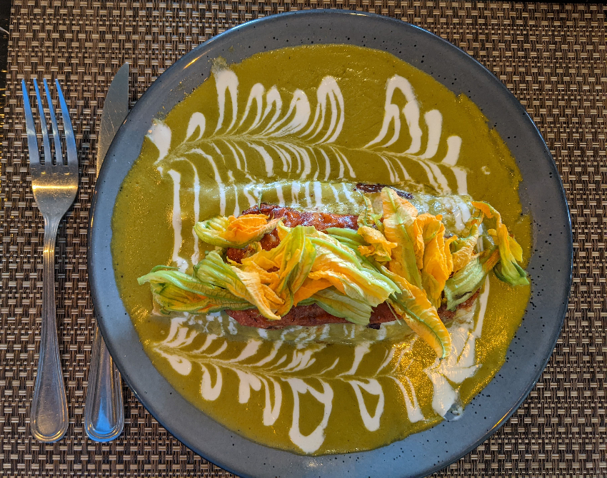 Enchiladas with squash blossoms on top